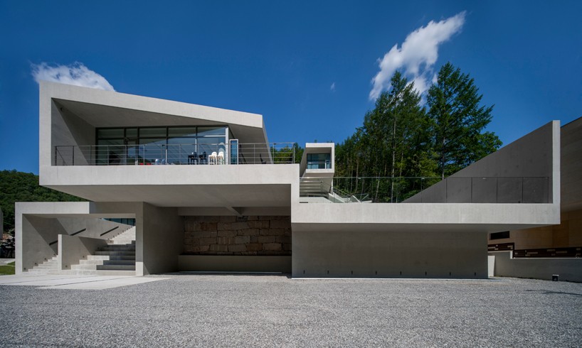 Concrete residence by IDMM architects with Garage