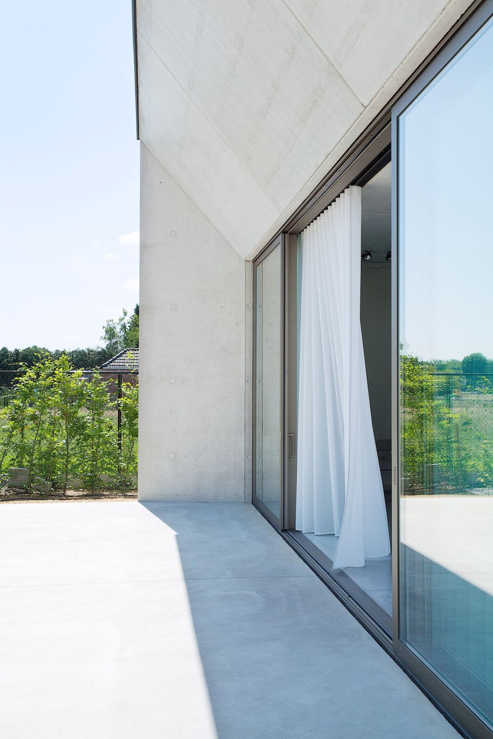 Concrete rural house by Clauwers Simon with large windows