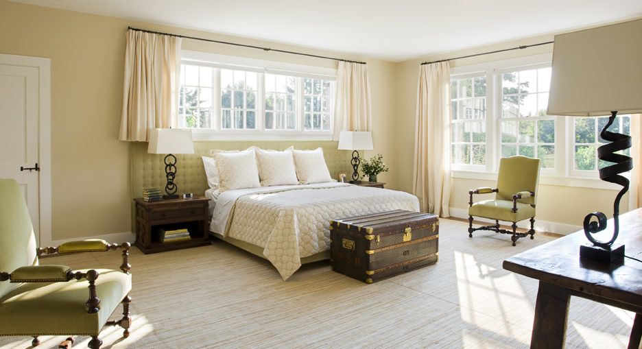 Serene and inviting, the master bedroom plays up the gentle green accent and textures through the room.