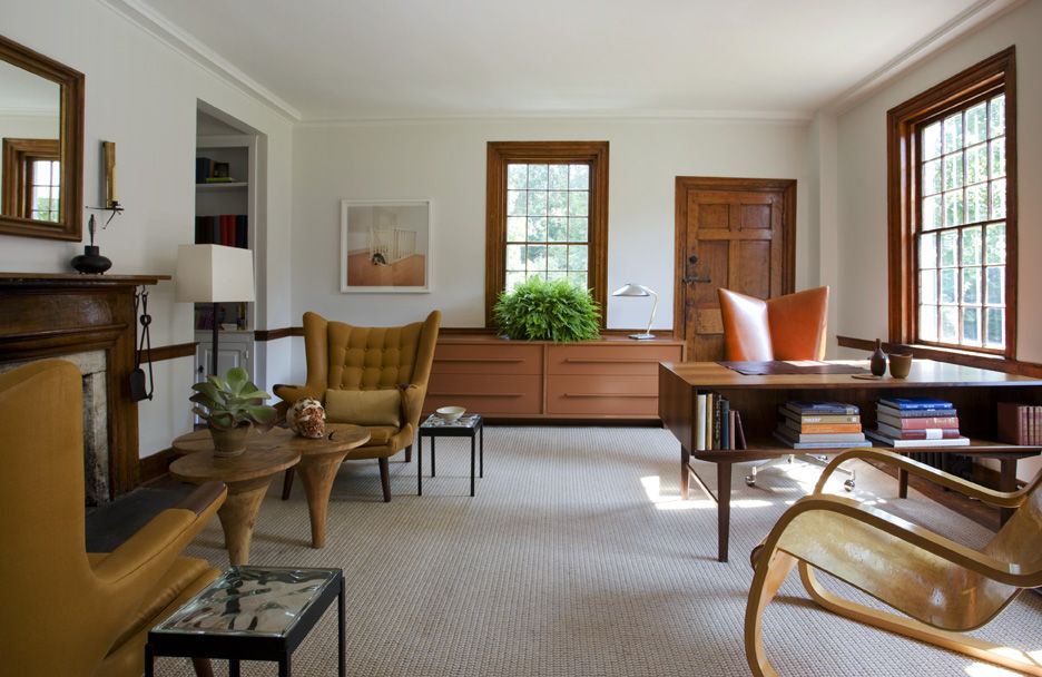 The farmhouse's office uses unique furnishings, such as the eye-catching one-legged conjoined tables.