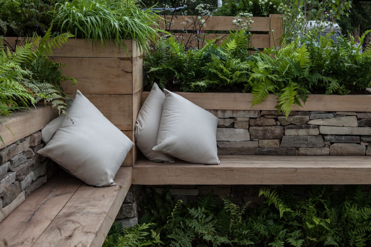 The bench can be built along an existing fence or you can let its backrest double as a divider and even as a planter