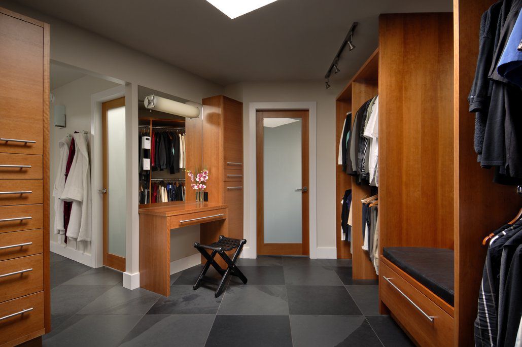 Corner walk in closet room with makeup vanity