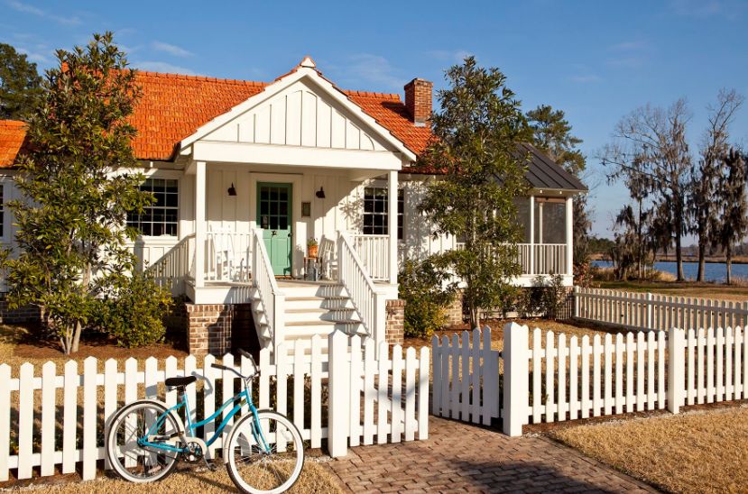 Cottage renovation house with white picket fence and bold front door