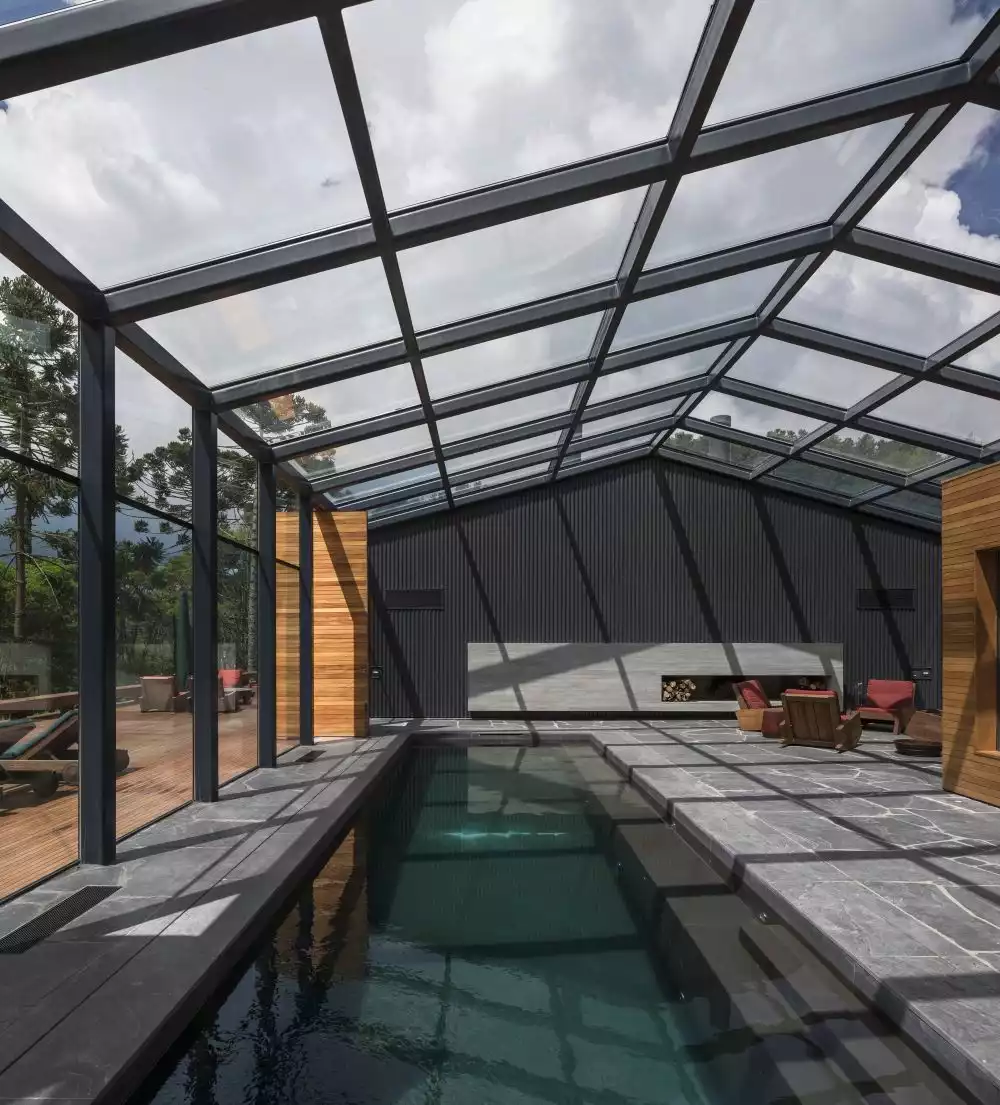 Covered swimming pool design with glass ceiling