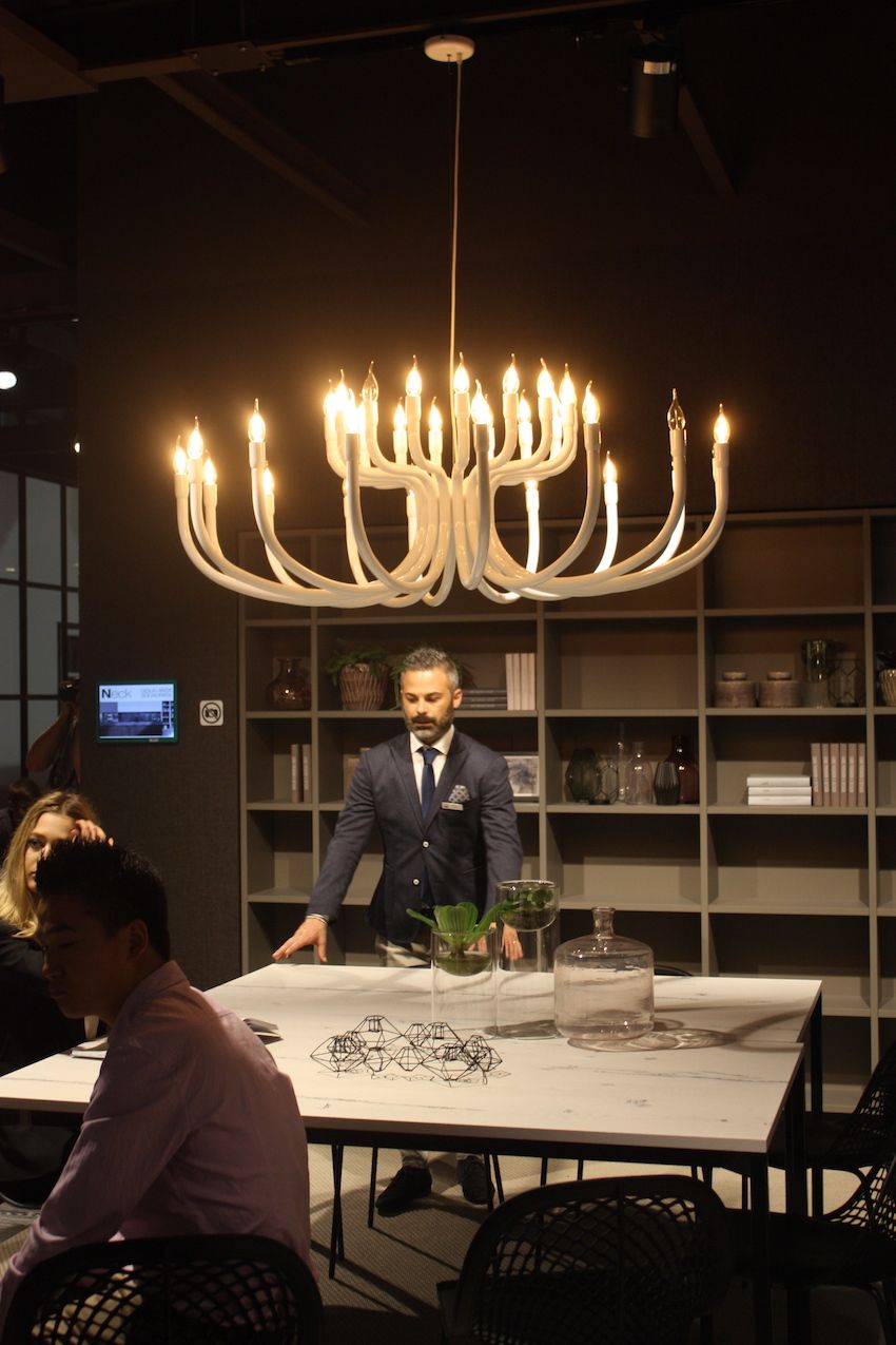 Cucine Lube's large chandelier has a modern flame look that evokes a bit of a rustic feel. Used over a dining table in this setting, it could also serve as dramatic kitchen island lighting.