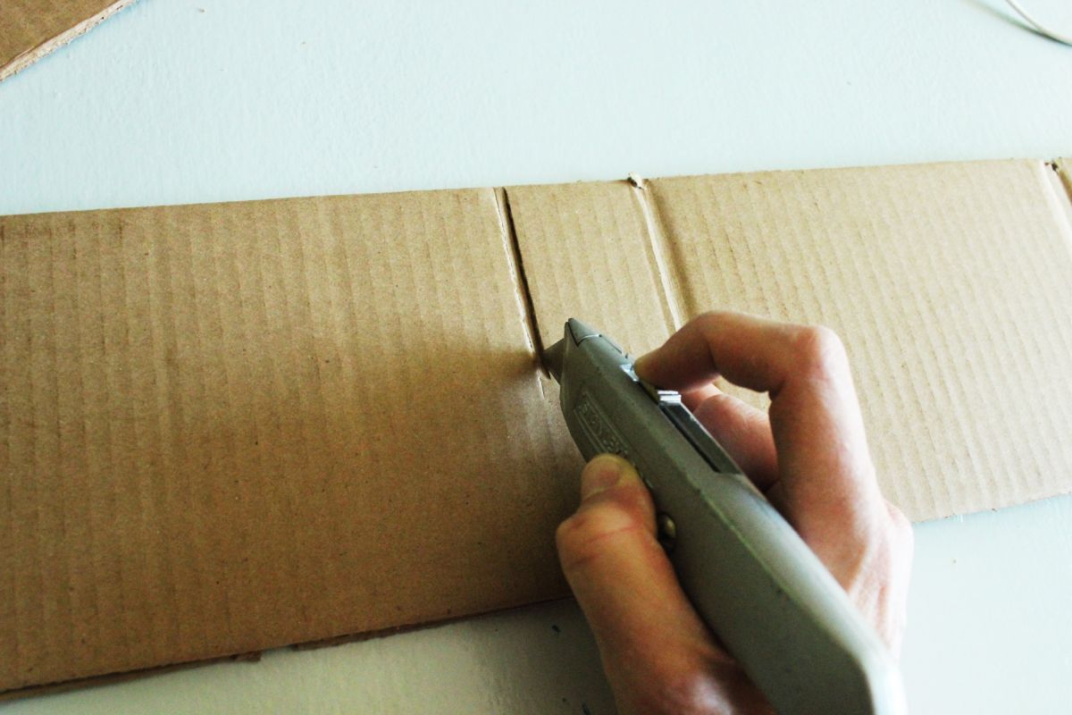 Use a box cutter and cut the cardboard