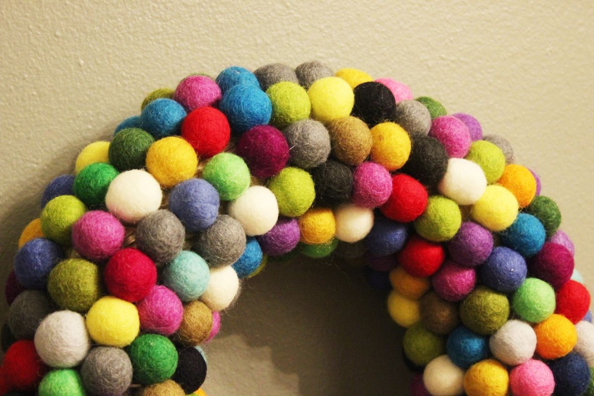 DIY Felt Ball Wreath-see the straw wreath between some of the felt balls