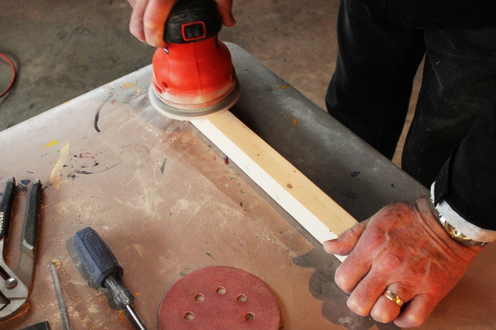DIY Toy Box sanding the wood pieces