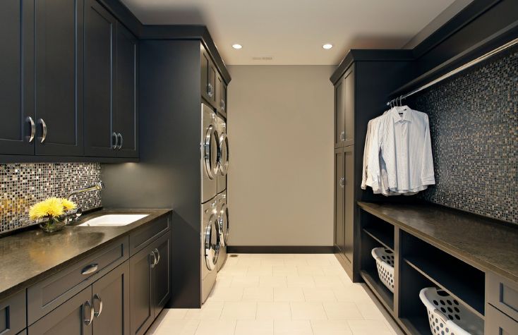 Dark laundry room design with mosaic backsplash