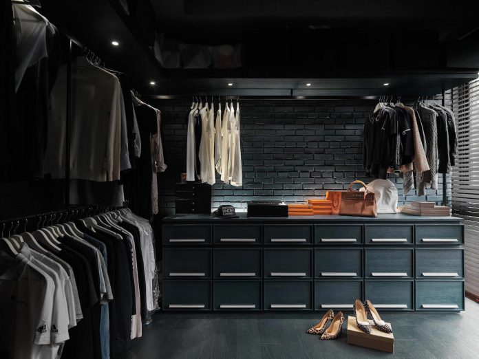 Dark masculine walk in closet design