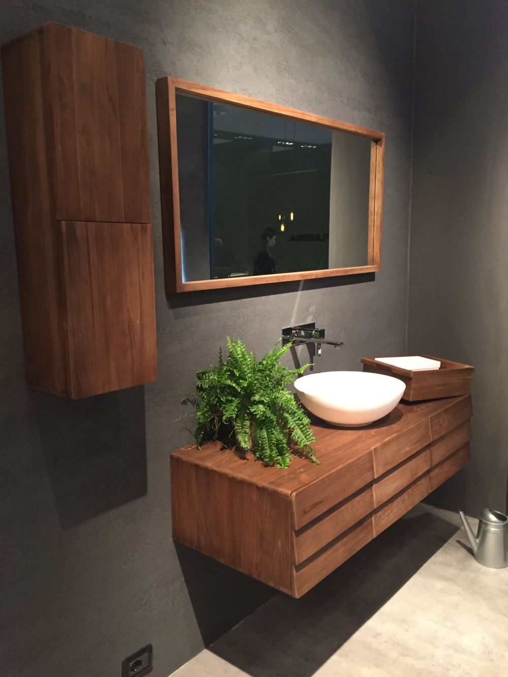 Decorate the floating vanity with green plants and round vessel sink