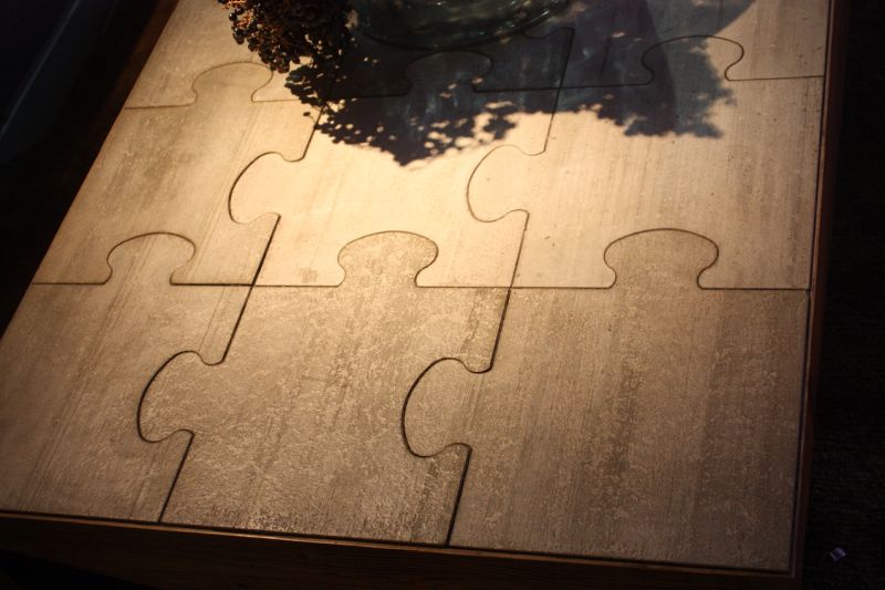 Even the sides of the wooden coffee table are puzzle-like...they seem to be missing a piece!