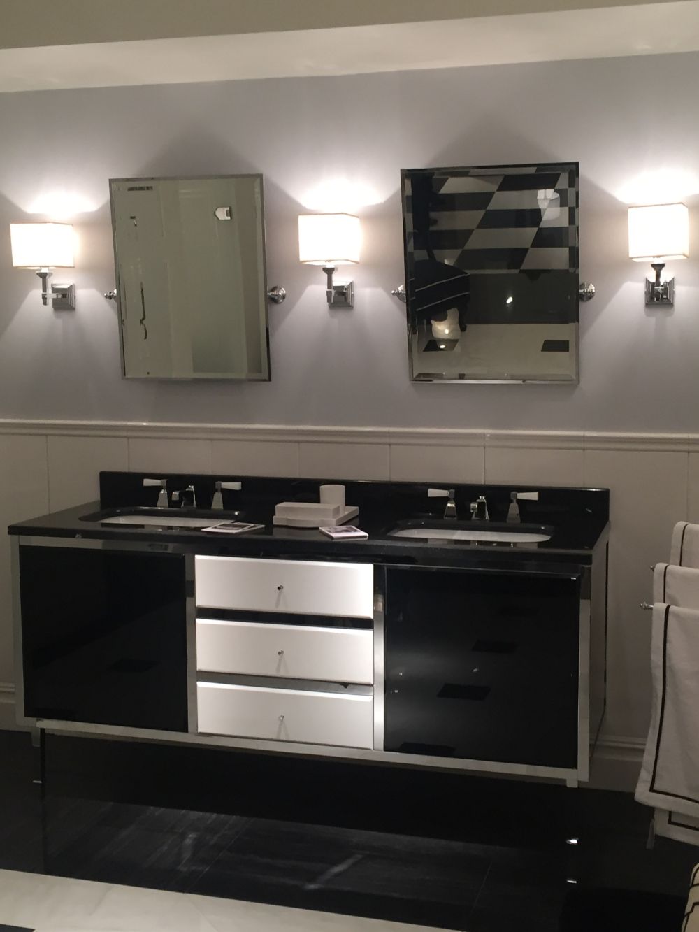 Double black bathroom vanity with small mirrors