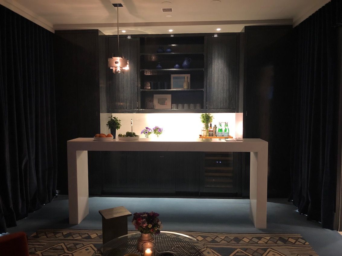 The dark, dramatic space is equipped with a bar sink.