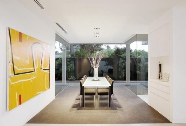 Elegant minimalist dining room yellow art work