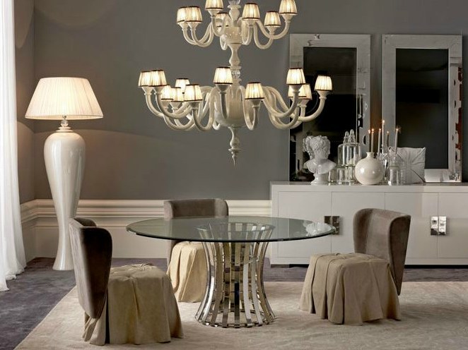 Empire round glass dining table and chandelier over