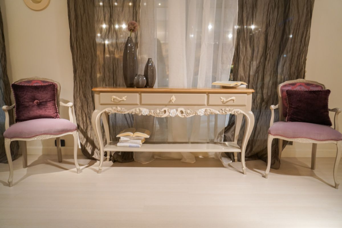 Entryway with velvet pink upholstered chairs and small console table with drawers