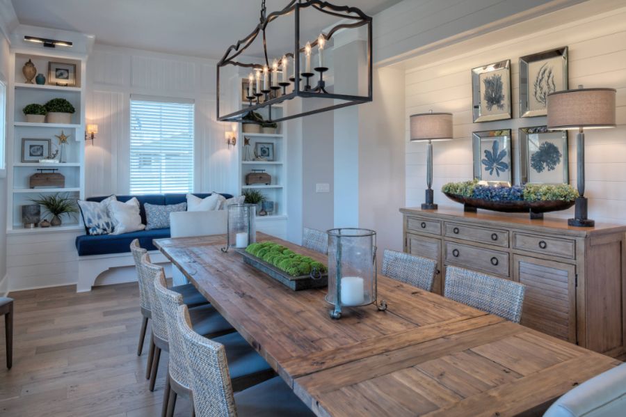 Example of a beach style medium tone wood floor and brown floor dining room design