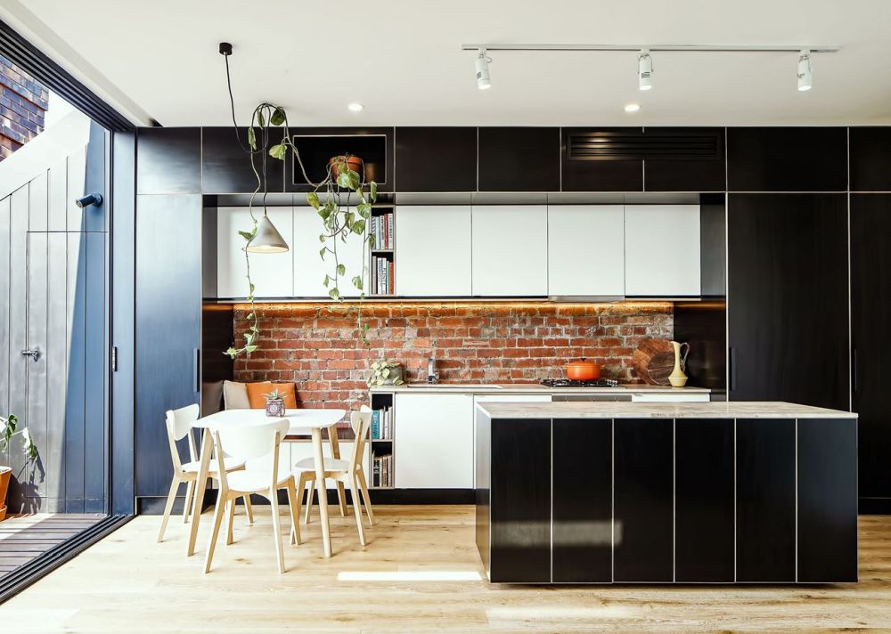 Exposed brick walls and combination of black and white for cabinets