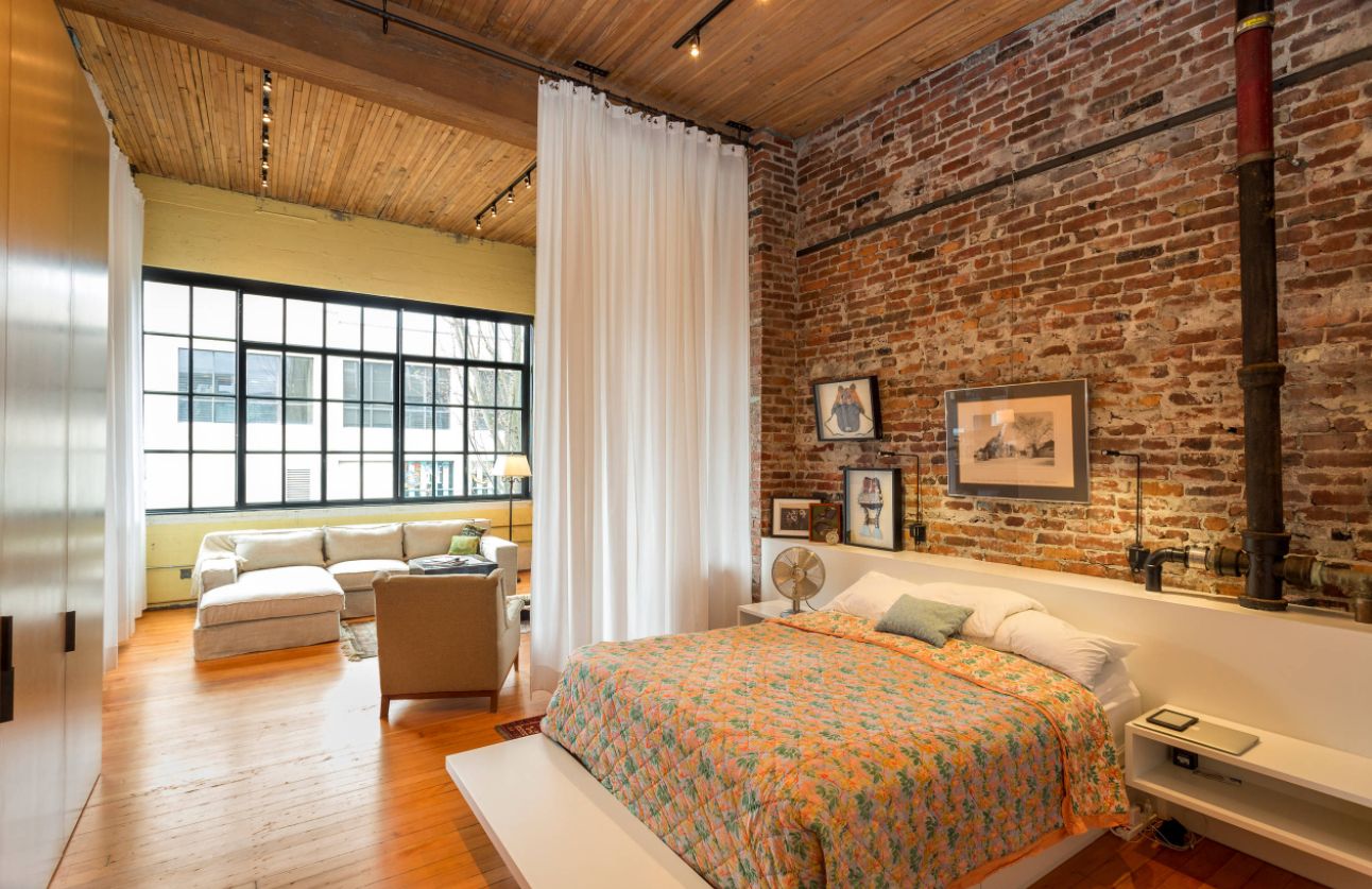 Exposed bricks wall and curtain room divider