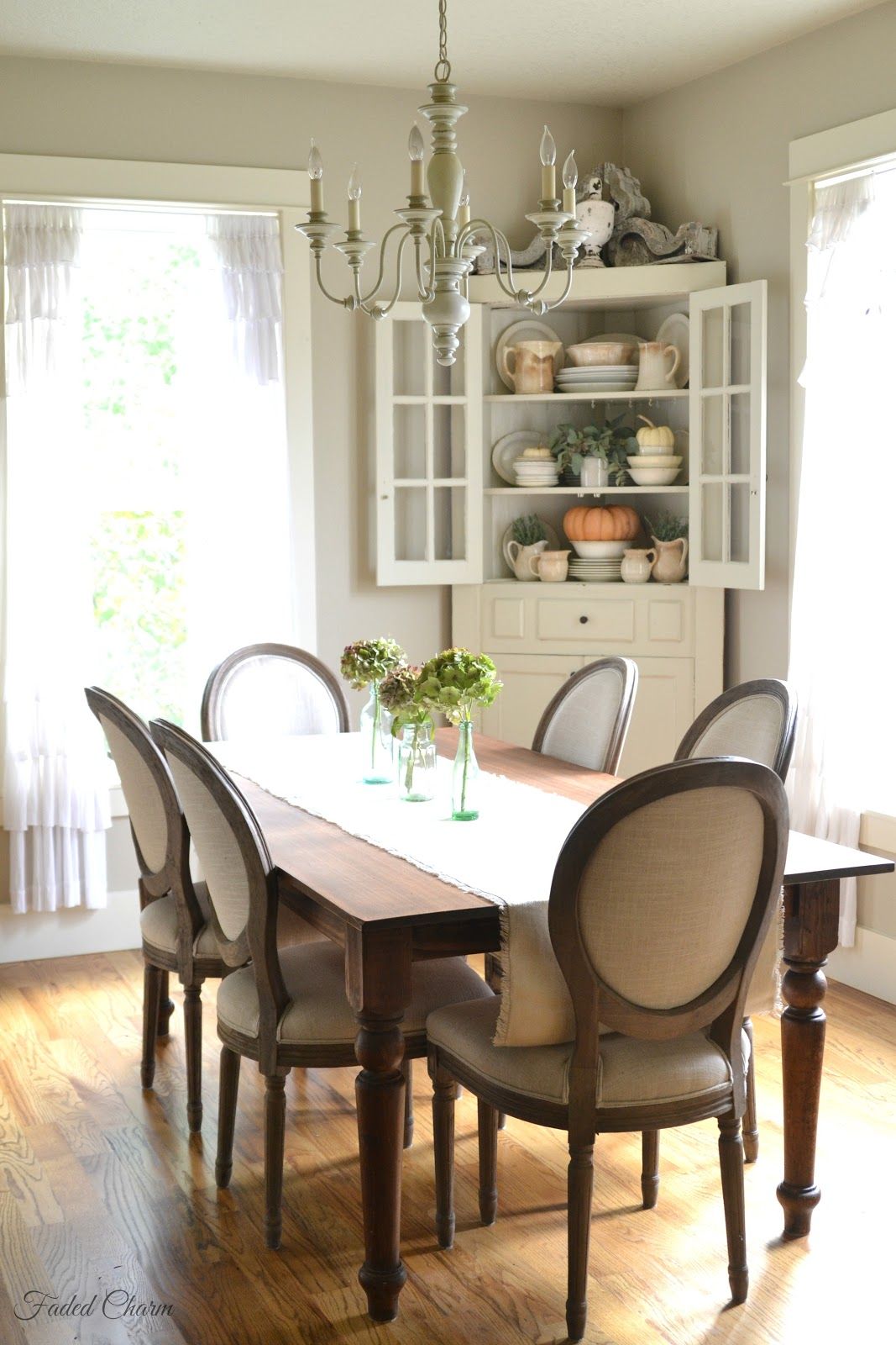 Farmhouse dining room decor with corner cabinet