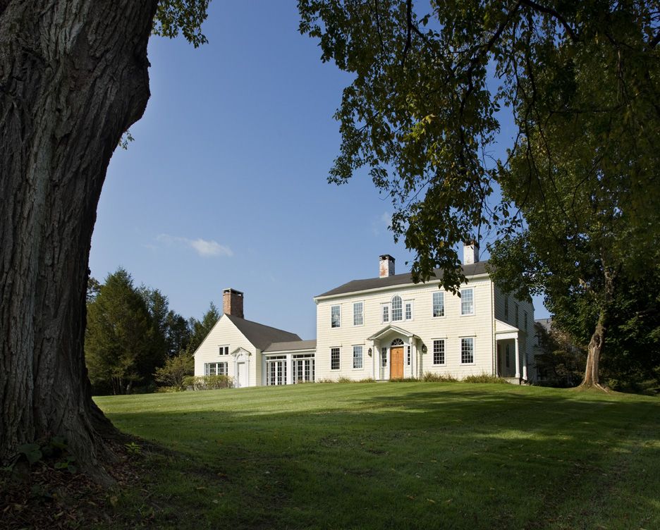 Farmhouse exterior with an amazing green lawn