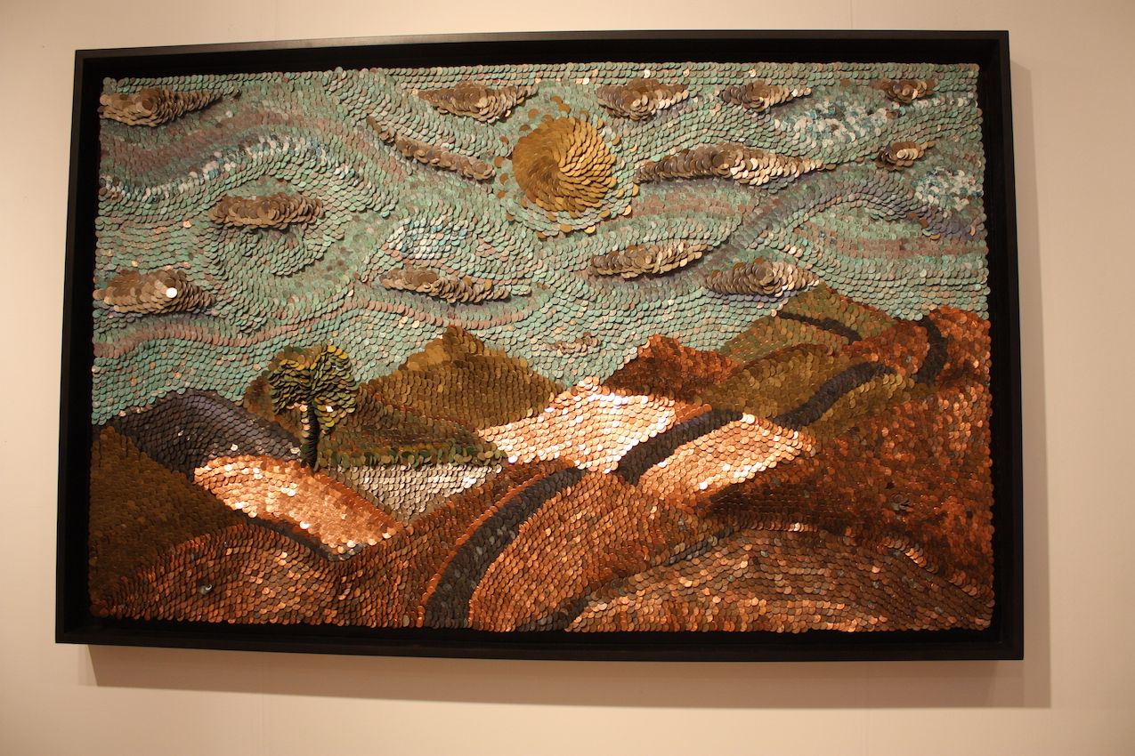 The orientation of the scale-like pieces are key to the textures in the work.