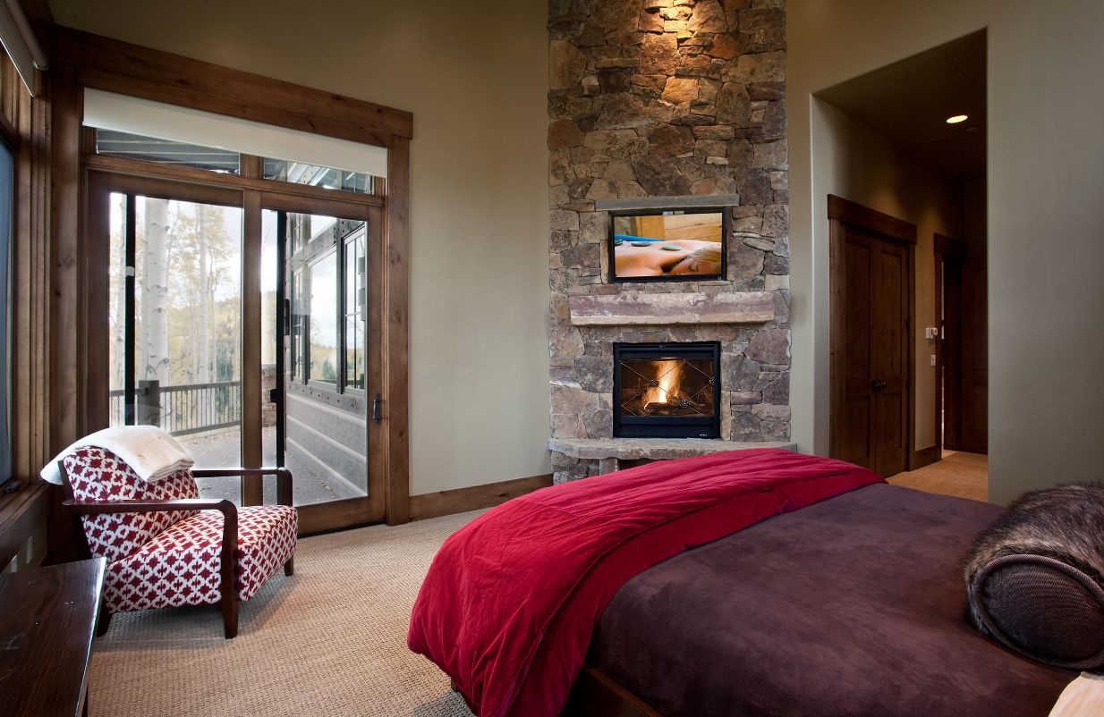 Fireplace from stone designed for corner in the bedroom