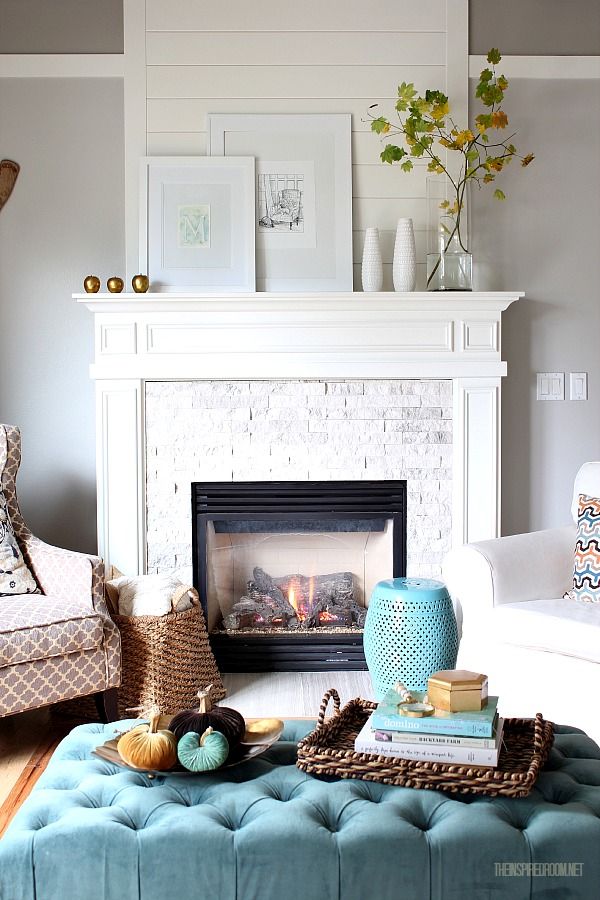 Fireplace mantel decorate with gold apples and frames