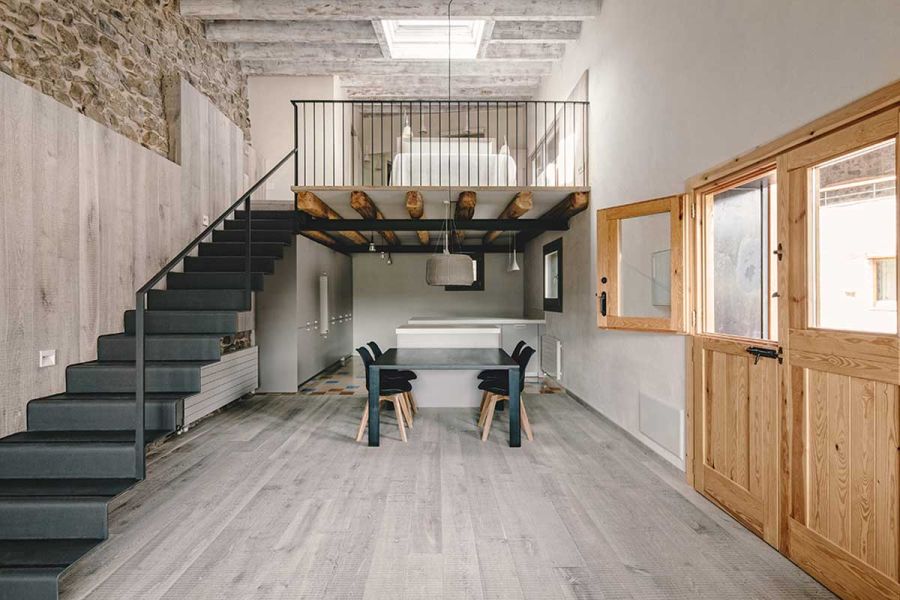 Floating zig-zag stairs with a wood and stone backdrop