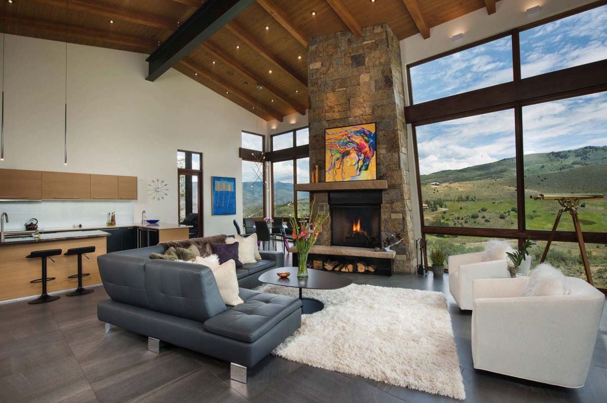 Floor to ceiling mountain view and large stone fireplace