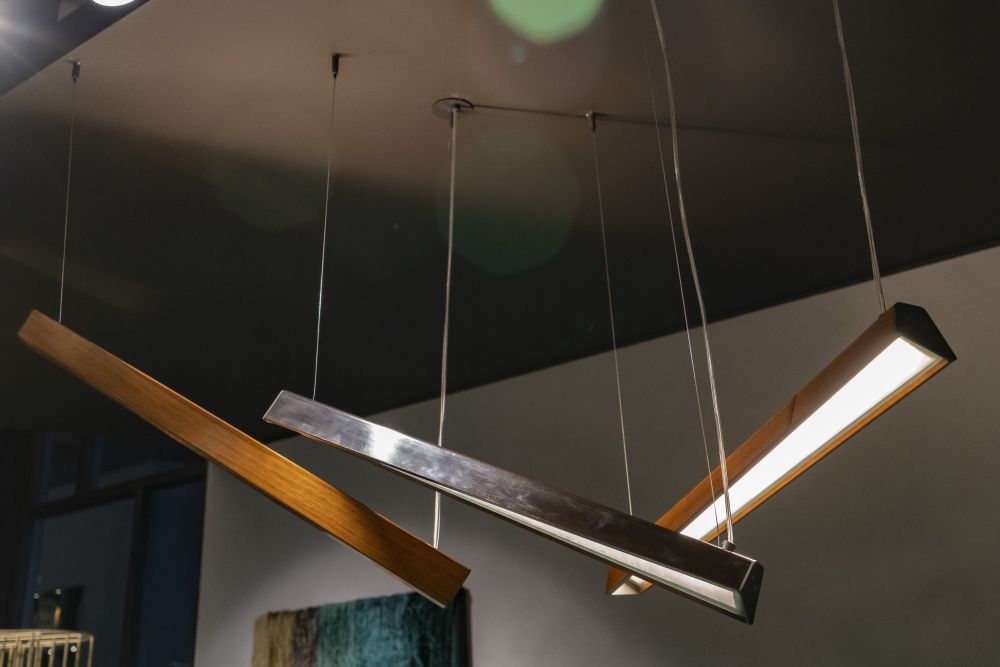 Modern, adjustable lights are more functional than plain pendants.