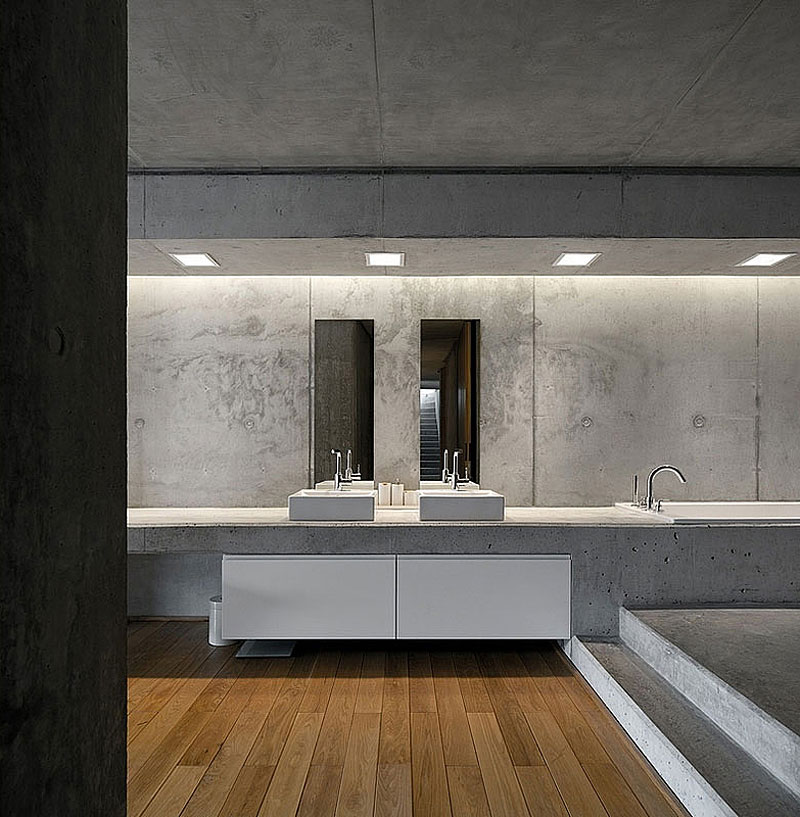 Full concrete bathroom design with wooden floor