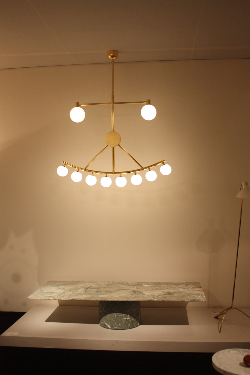 The light hangs above the ‘‘M&C coffee table’’ by Pierre Charpin.