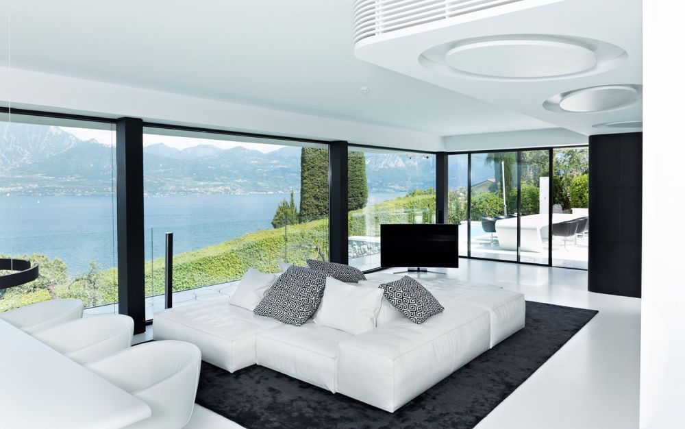 Garda Lake House white living room furniture with accent rug and amazing views