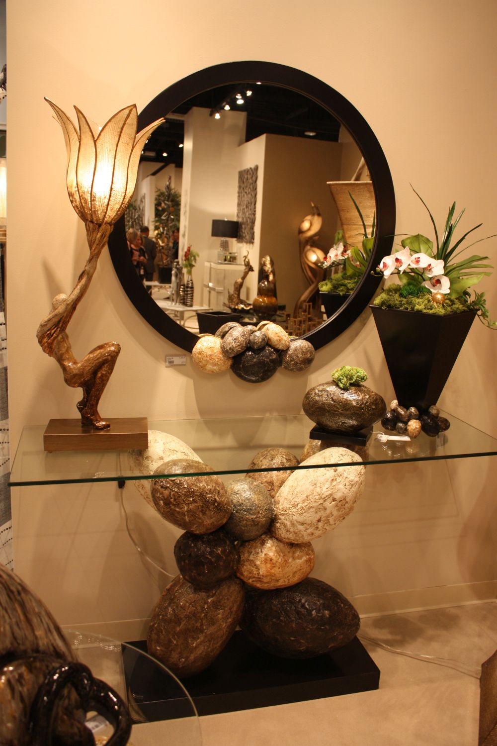 Glass top console with an interesting base and round mirror