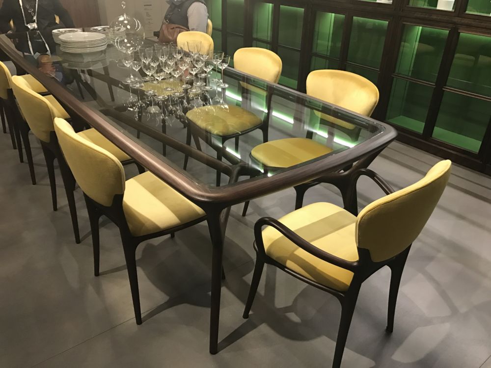 Glass top dining table with yellow chairs