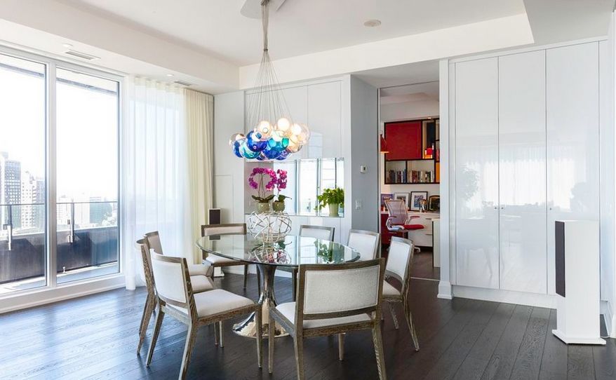 Globe chandeliers above the glass dining table