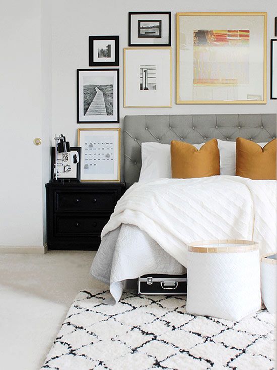 Gray bedroom headboard with frames above