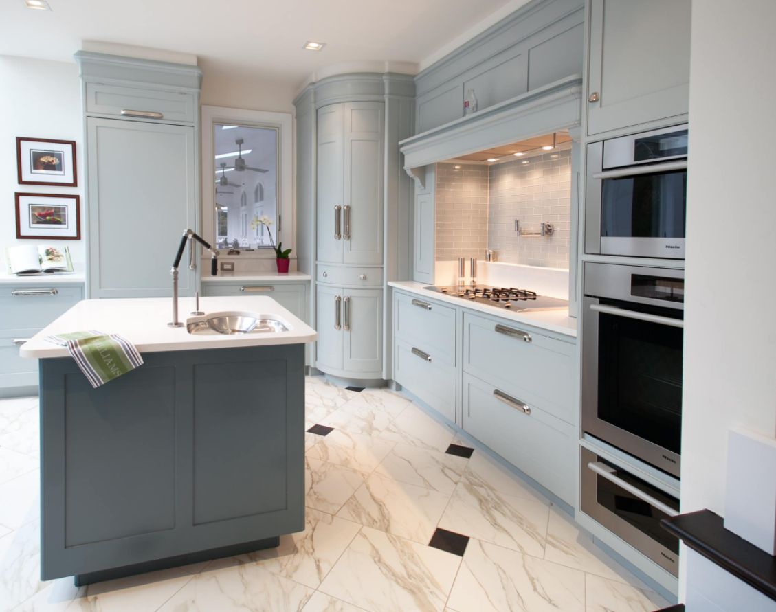 Gray kitchen design with curved doors for corner cabinet