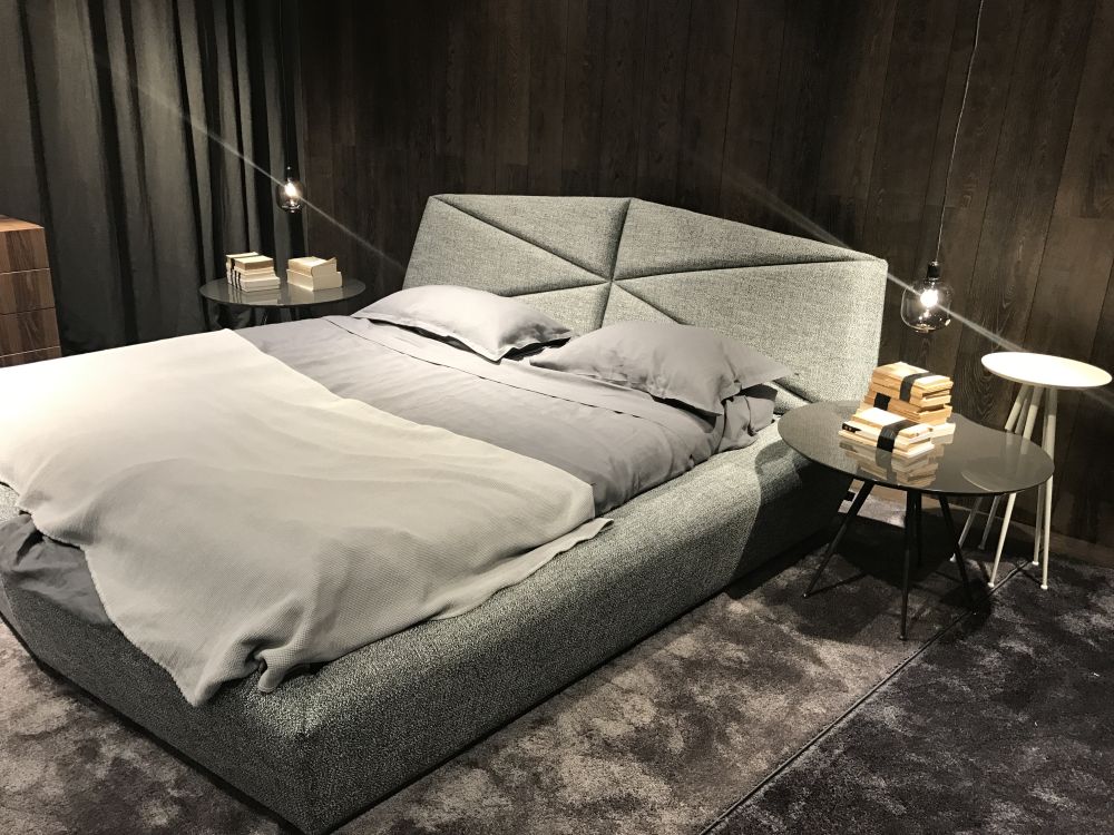 Gray upholstered bed with geometric headboard