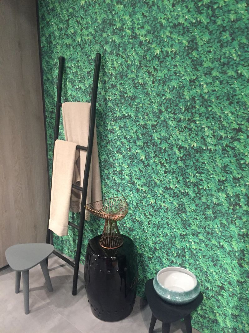 Green bathroom wallpaper and black accessories