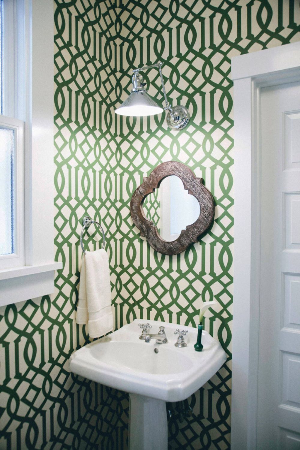 Green bathroom wallpaper with a geometric pattern