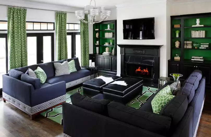 Green living room with black cowhide ottomans