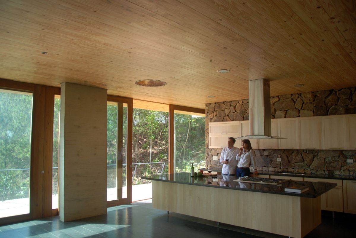 Green roof house by VASHO Kitchen with Stacked Stone Wall