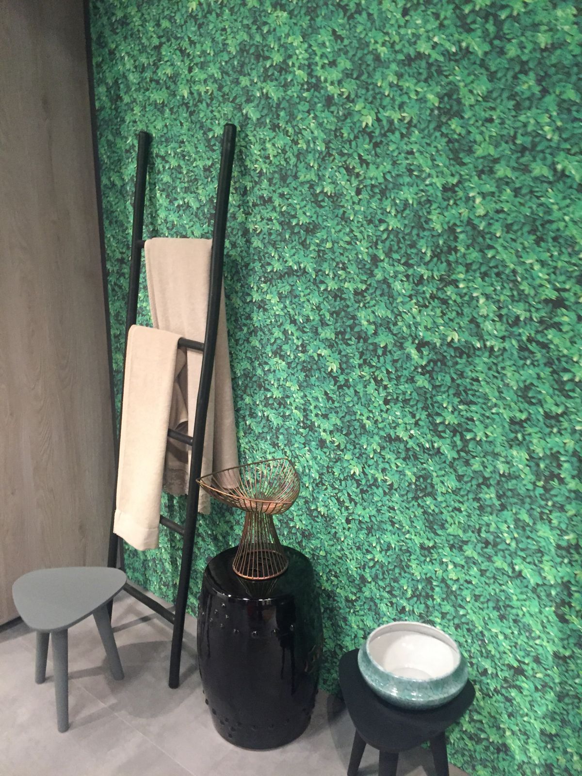 Green wallpaper for bathroom and ladder to towels