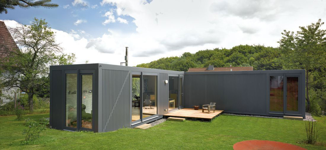 Grey container home with a small deck