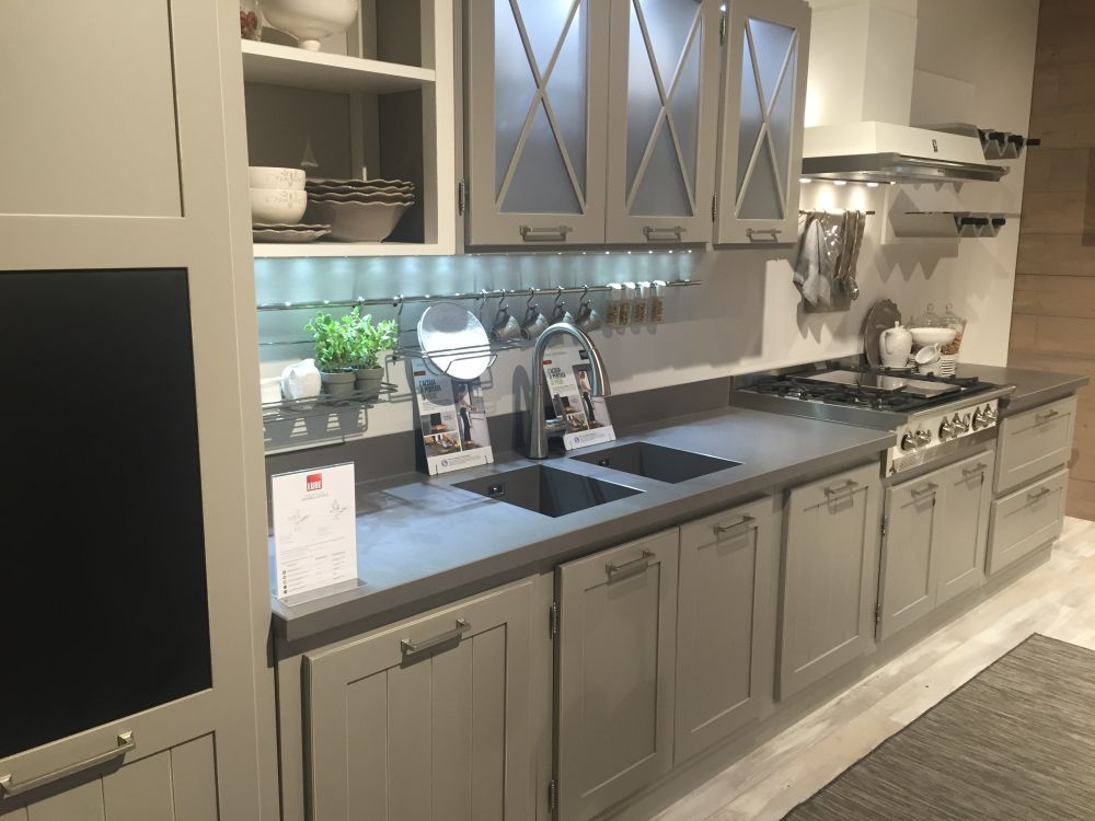 Grey kitchen cabinets with stained glass doors