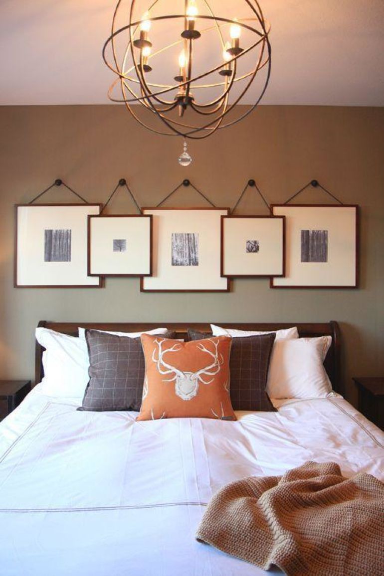 Hanging frames above the bed