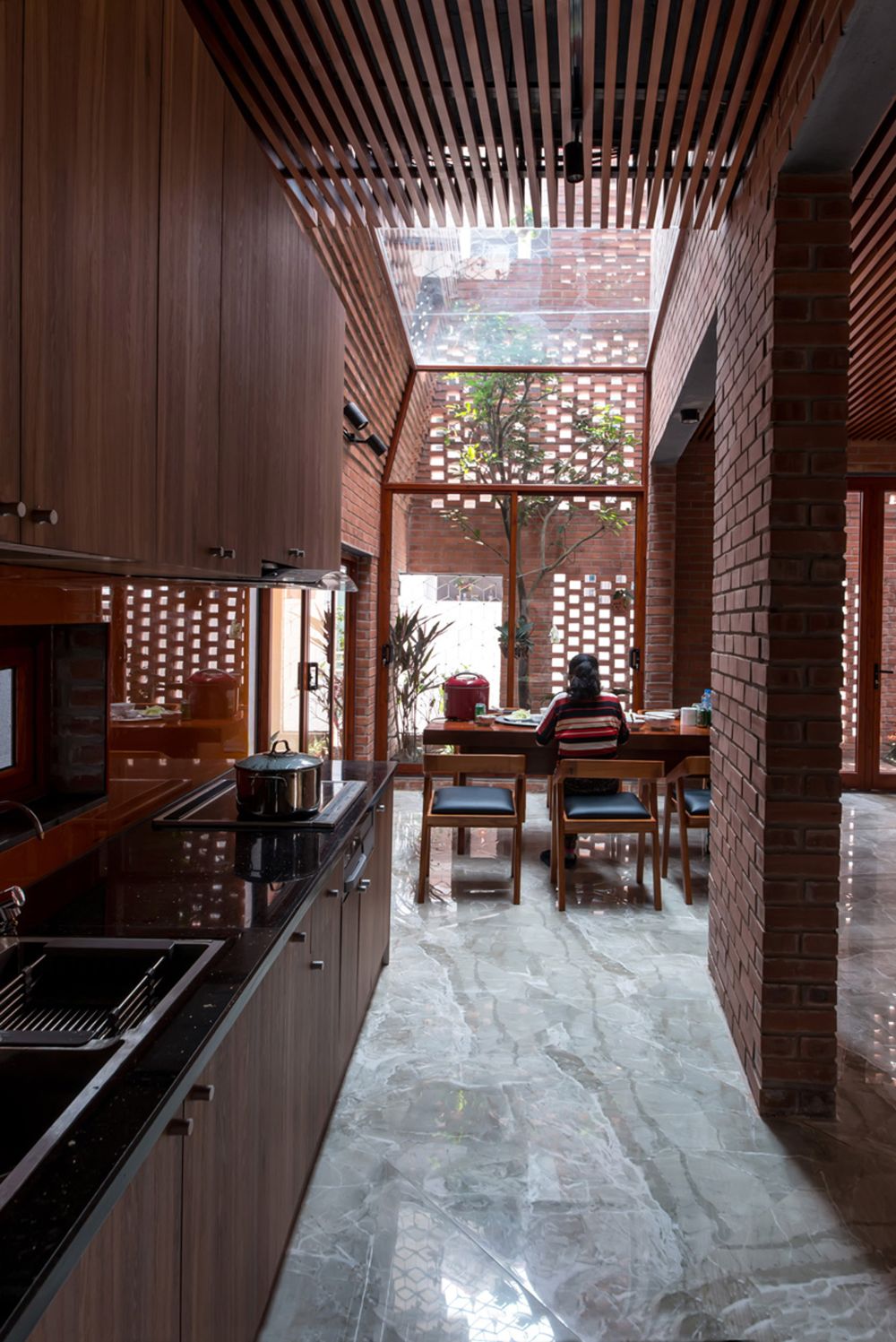 Hanoi perforated brick facade by Vietnamese studio H&P Architects - kitchen and dining